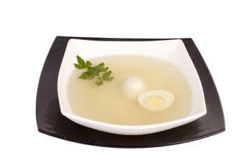 Chicken broth with dill and egg, isolated on white