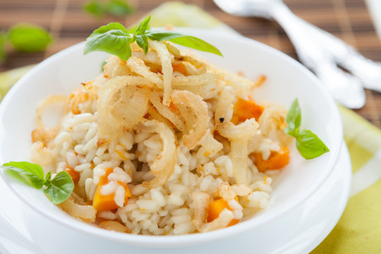 risotto with crispy onions in whie bowl