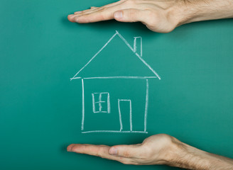 Drawing house on chalkboard