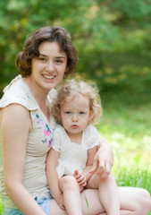 Fototapeta premium Girl and her mother are relaxing in the park