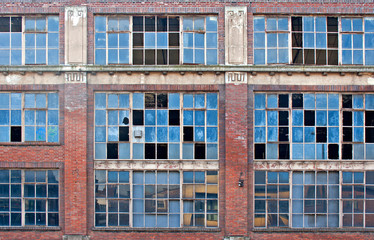 Broken windows on old derelict building - 49975028