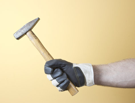 The hand  holding the hammer