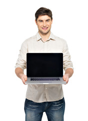 man holds laptop with blank screen
