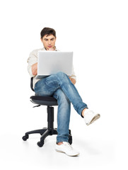 man working on laptop sits on the chair