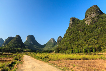 Sand road through a valley with limestone rocks