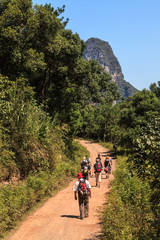 Group of people walking through limestone rock valley