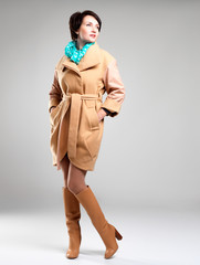 Full portrait of fashion woman in autumn coat with green scarf