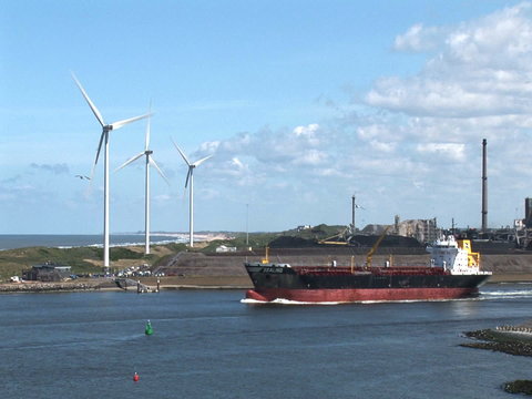 The Industrial Port Of Ijmuiden- Cargo Ship And Wind Turbines