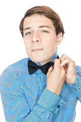 Handsome old-fashioned gentleman adjusting his bow tie