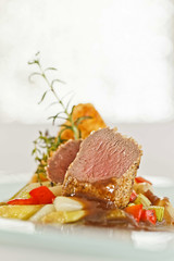 Roasted saddle of lamb on asparagus ragout and herbs