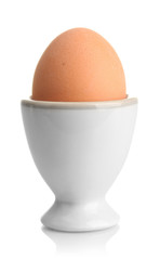 Whole boiled egg in egg cup, isolated on white