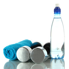 Dumbbells with towel and bottle of water isolated on white