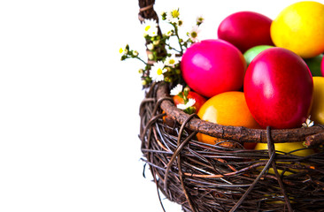 Colorful easter eggs in brown basket