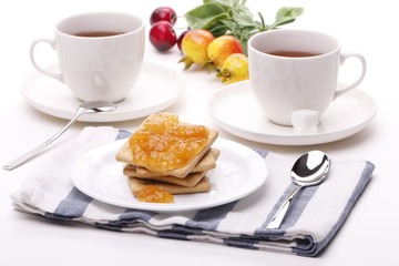 Biscuit with jam and teacup