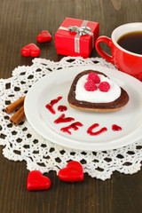 Chocolate cookie in form of heart with cup of coffee