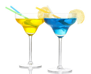 Yellow and blue cocktails in glasses isolated on white