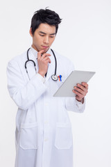 Young Asian doctor using tabet pc