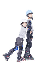 Fototapeta na wymiar Brothers playing rollerblades over white background