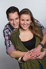 Happy young couple in love. Man and woman. Studio shot.