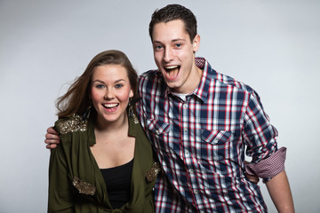 Happy young couple in love. Man and woman. Studio shot.