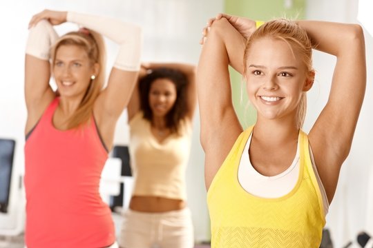 Pretty girl exercising in group