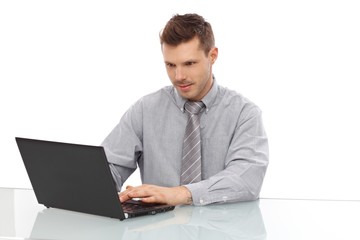 Young man working on laptop smiling