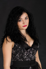 Naklejka premium Portrait of young woman with black dress posing