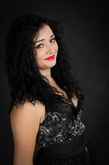 Fototapeta premium Portrait of young woman with black dress posing