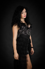 Fototapeta premium Portrait of young woman with black dress posing