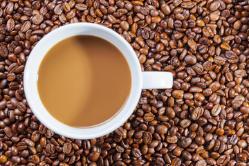 delicious hot coffee on coffee-beans