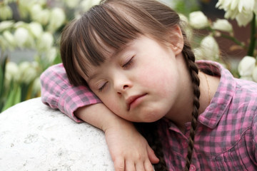 Portrait of beautiful young girl sleeping outside