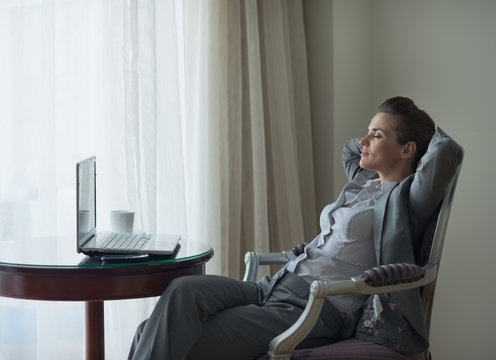 Relaxed Business Woman Sitting In Chair In Hotel Room