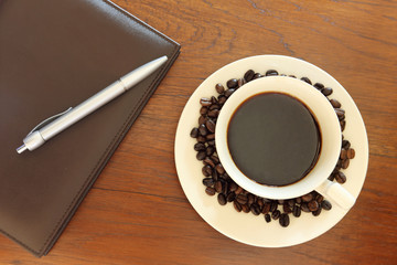 Fototapeta na wymiar coffee cup with note book