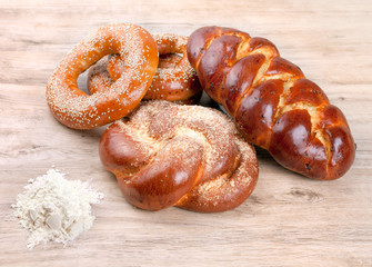 Variety of baked buns on wood table