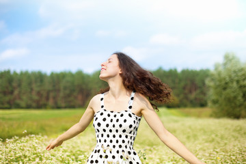 Young happy girl walking on the buckwheat field