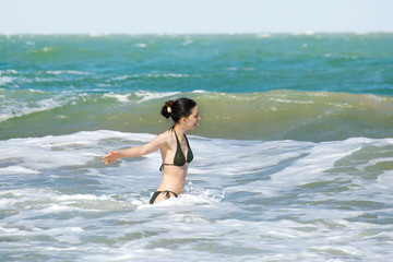 Fototapeta premium Happy girl splashing in the waves