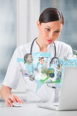 Female medical doctor surfing on web with modern laptop