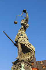 Fototapeta na wymiar Statue of Lady Justice in front of the Romer in Frankfurt - Germ