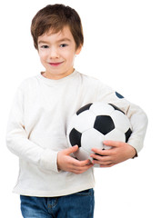 Little boy playing soccer ball