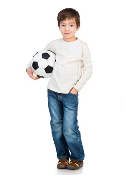 Little boy playing soccer ball