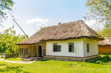Plakat A typical antique Ukrainian country house or farm with a thatch roof, in the countryside near Kiev 