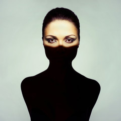 Fototapeta premium Surrealistic young lady with shadow on her body