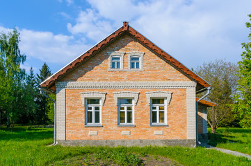 Fototapeta na wymiar A typical Ukrainian brick house, in the countryside near Kiev 