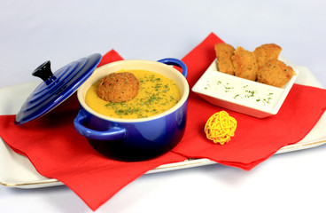 Lentils cream soup with ginger and curry and falafel
