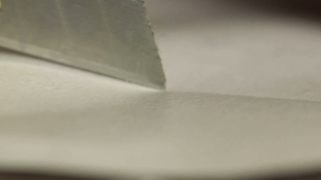 Cutting paper with knife