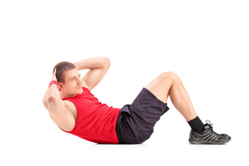 Fototapeta premium Young man doing abbs on the floor
