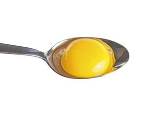 Chicken egg yolk in spoon