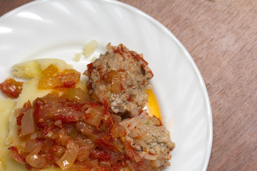 cutlet with potatoes in tomato sauce