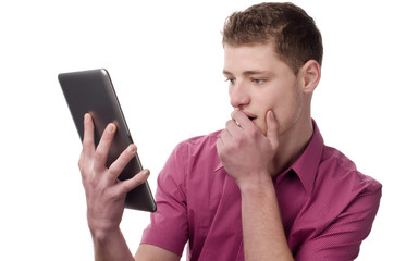 Man holding a tablet and reacting amazed and surprised.
