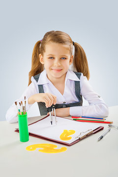 a little girl with crawing compass